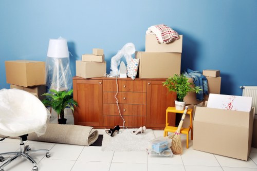 Professional movers packing office equipment securely