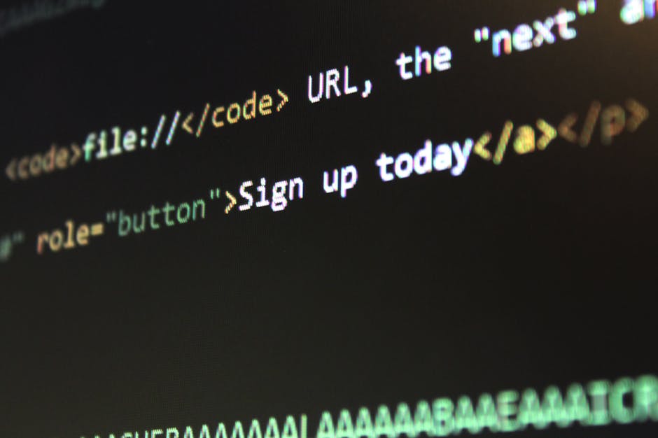 Close-up view of a computer screen displaying lines of HTML, CSS, and JavaScript code in a dark environment with a blue hue. The code includes stylesheet links, script include statements, and comments